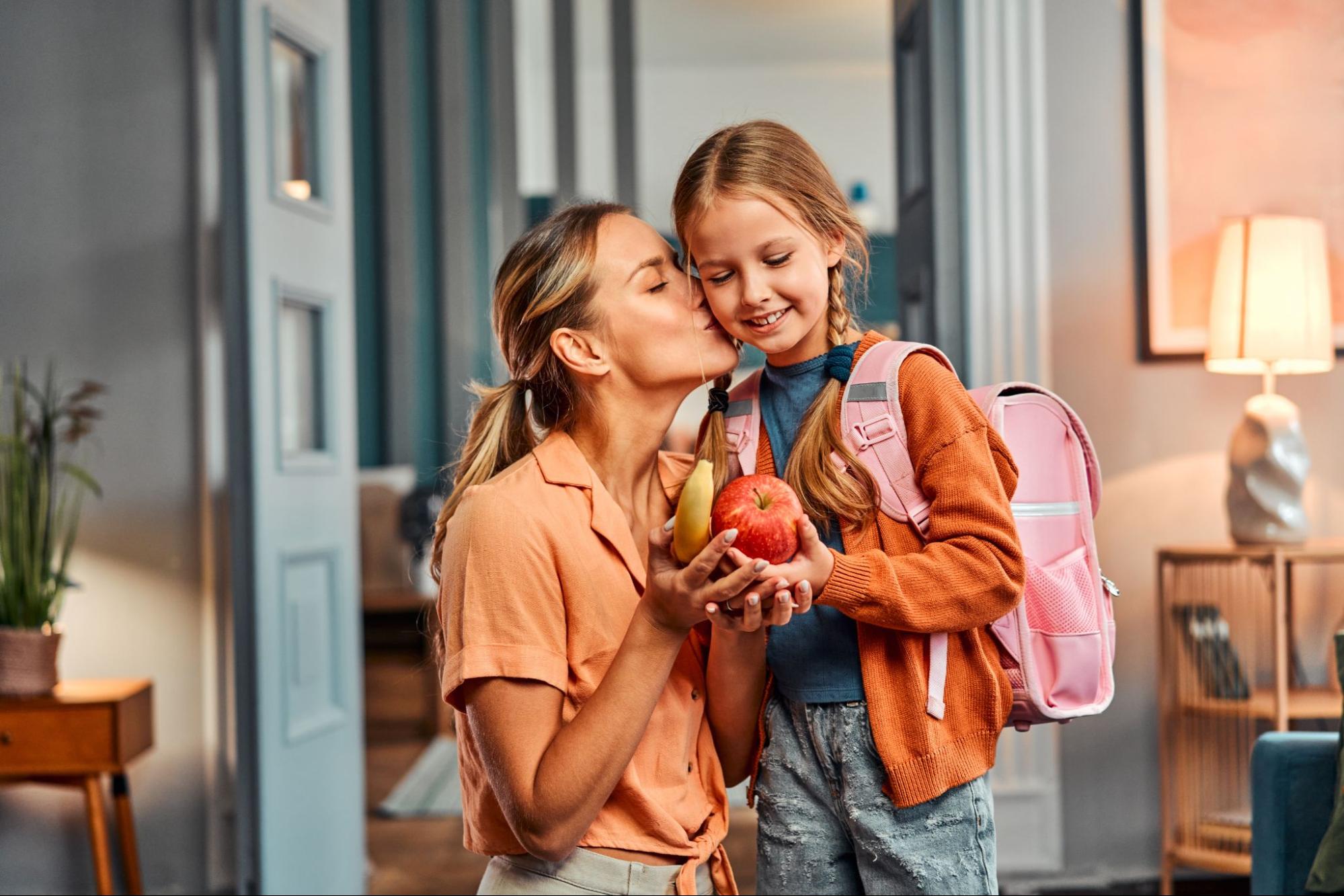 Mother sending daughter off to school.