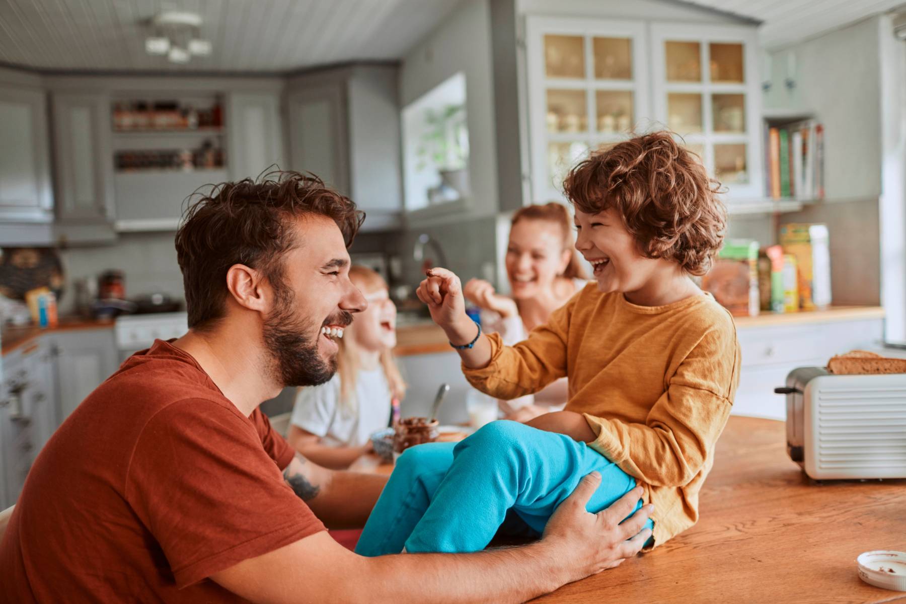 Happy family enjoying time at home supported by netWell’s affordable healthcare sharing plan.